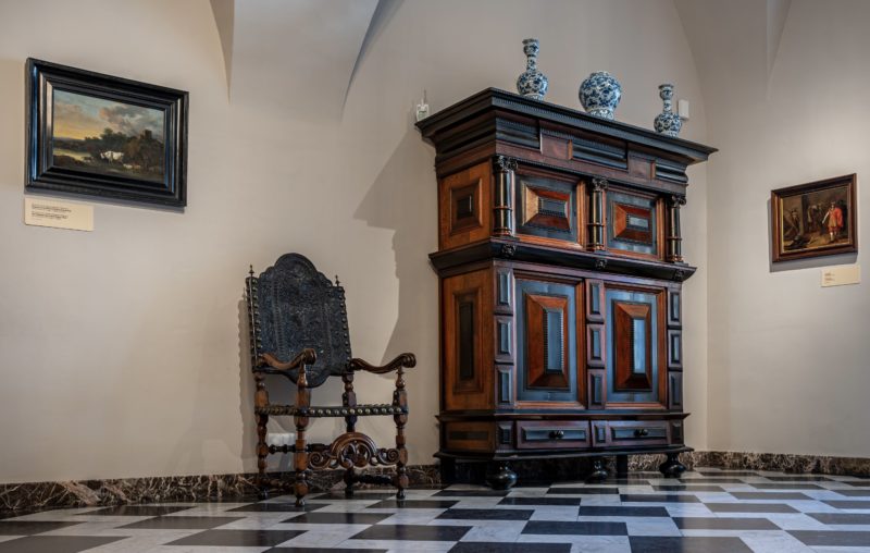 Krakow, Poland, March 23, 2024 - Antique furniture and patterned tiles at the interior of the Wawel castle NieWĄSkie spojrzenie. Ikea, Ludwik Filip i zydel