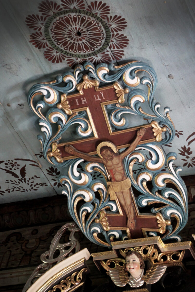 Wnętrze cerkwi w Brunarach Wyżnych. Zdjęcie przedstawia krzyż protestancki z Jezusem Chrystusem w środku.