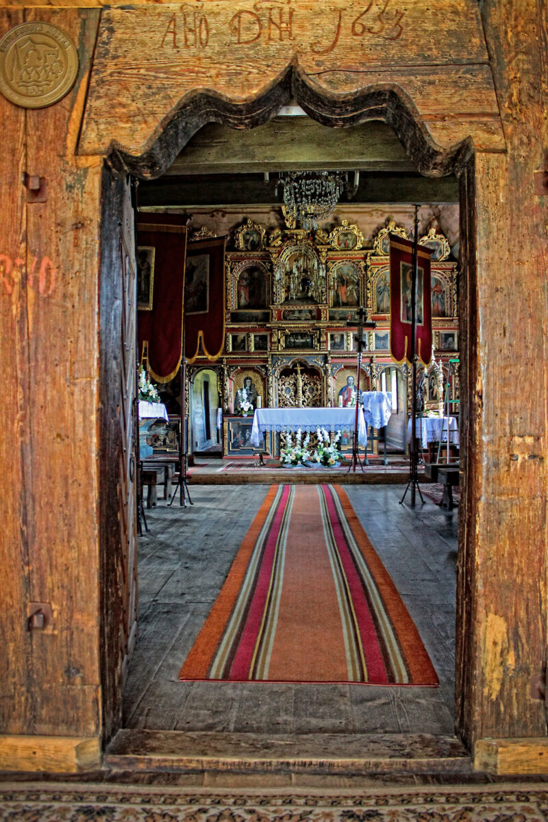 Wejście do cerkwi w Owczarach przez łuk. W środku ikonostas i ołtarz.