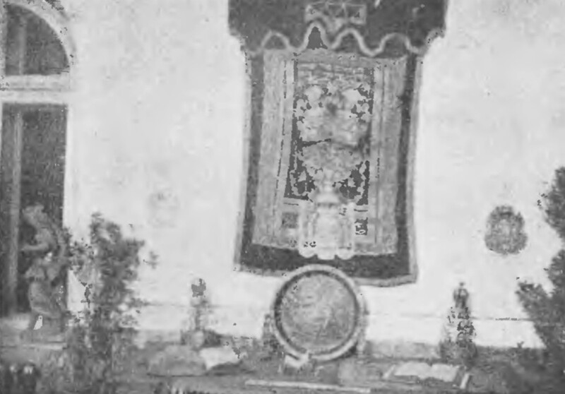 Wystawa Historyczna Miasta Stanisławowa. Na zdjęciu widać zarysy eksponat&oacute;w nawiązujących do bogatej historii Żyd&oacute;w w Stanisławowie. Ścianę zdobi zasłona tory z szafy ołtarzowej (aron ha-kodesz) domu modlitwy Halpern&oacute;w z 1799 roku ze złotymi zdobieniami na czerwonej tkaninie. Poniżej umieszczono dwie korony ze srebra, także z domu modlitwy Halpern&oacute;w. Centralne miejsce zajmuje miednica do zlewania rąk kapłan&oacute;w z 1573 roku z Wielkiej Synagogi. Reprodukcja: J. G. [J. Grabowski], Muzeum Pokuckie w Stanisławowie, &bdquo;Ziemia&rdquo;, 1932, nr 10-12
